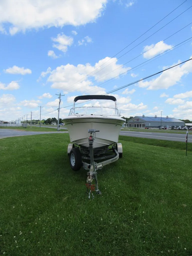 Slide: The Image of 2009 Grady-White Tournament 185 boat on trailer, parked on grass under blue sky. - 4