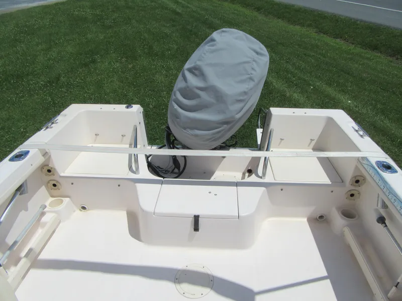 Slide: The Image of 2009 Grady-White Tournament 185 boat interior with covered outboard motor. - 7