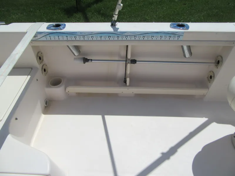 Slide: The Image of 2009 Grady-White Tournament 185 boat interior with fishing rod holders and measuring tape. - 9