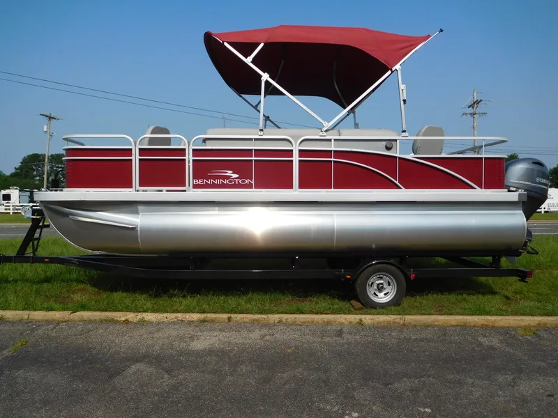 Slide: The Image of 2024 Bennington 20 SVF pontoon boat with red canopy and silver pontoons. - 1