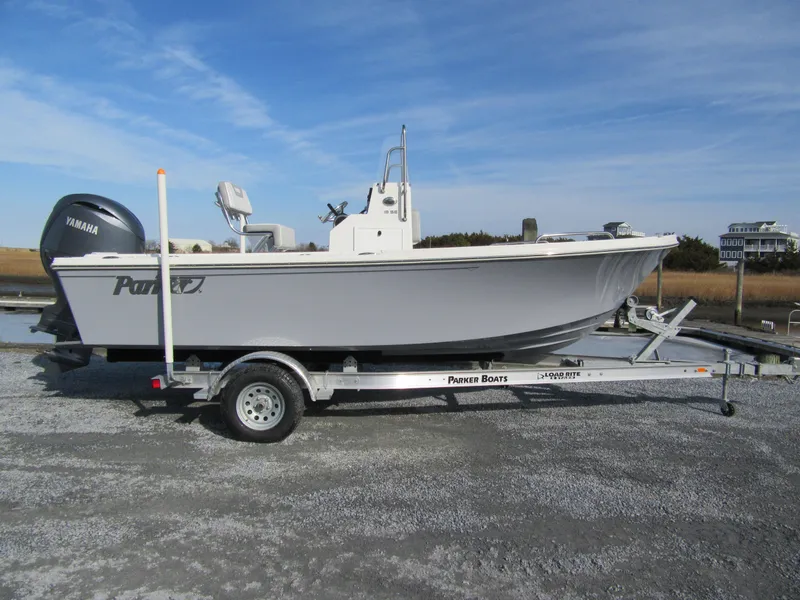 The Image of 2024 Parker 18SE Center Console boat on trailer, side view, outdoors. - 2