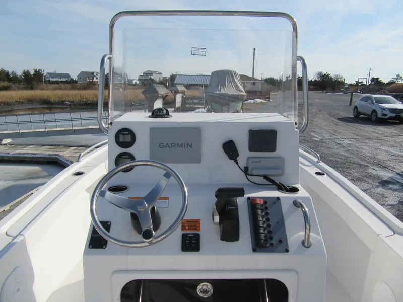 Slide: The Image of 2024 Parker 18SE Center Console boat with Garmin navigation system, docked outdoors. - 3