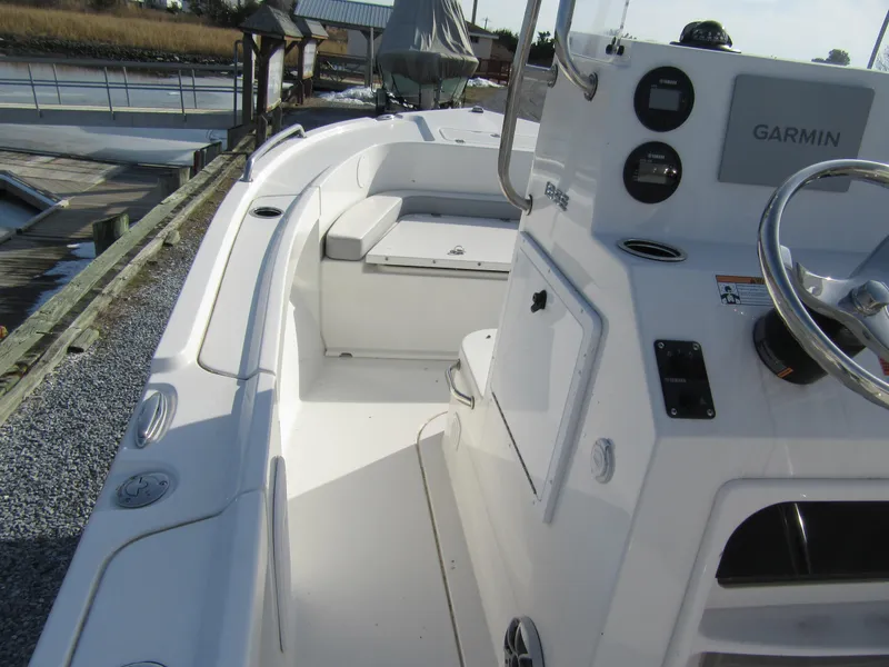 Slide: The Image of 2024 Parker 18SE Center Console boat with Garmin navigation, docked by a wooden pier. - 6