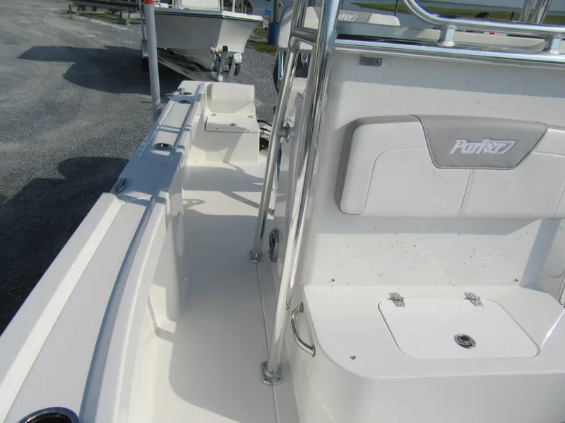 Slide: The Image of 2024 Parker 18SE Center Console boat interior, white seating and storage compartments. - 9