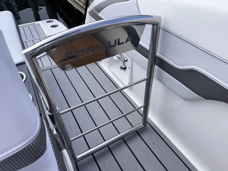 Slide: The Image of 2025 Formula 350 Crossover Bowrider I/O, sleek interior with stainless steel accents. - 10