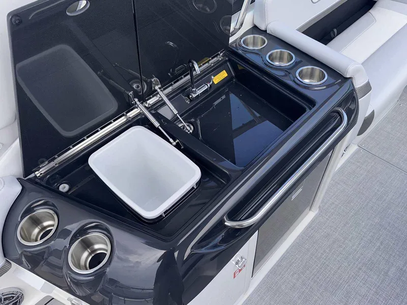 Slide: The Image of 2025 Formula 350 Crossover Bowrider I/O boat kitchenette with sink and cup holders. - 18