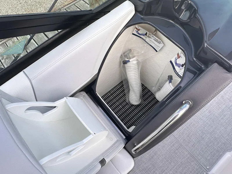 Slide: The Image of 2025 Formula 350 Crossover Bowrider I/O storage compartment with white interior and accessories. - 20