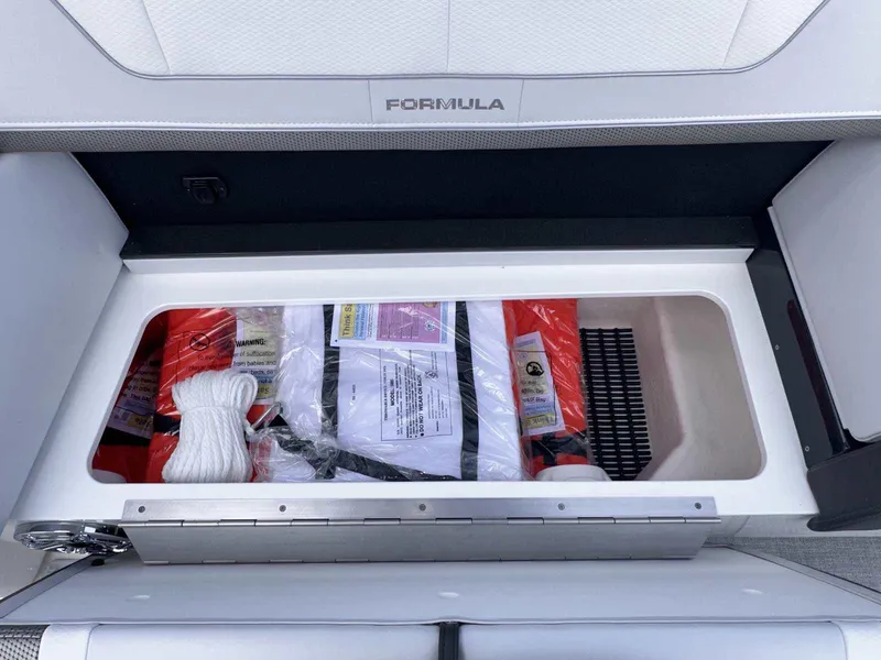 Slide: The Image of Storage compartment in 2025 Formula 350 Crossover Bowrider I/O with safety equipment. - 21