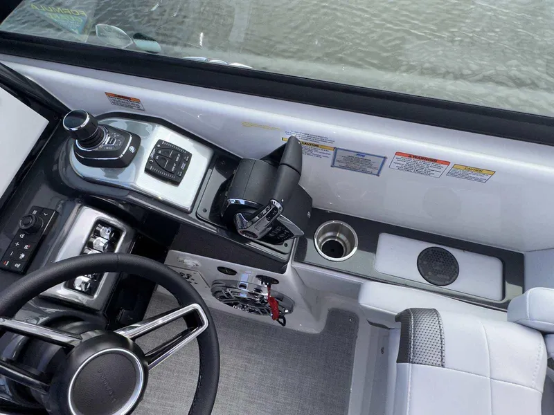Slide: The Image of 2025 Formula 350 Crossover Bowrider I/O helm with steering wheel and controls. - 26