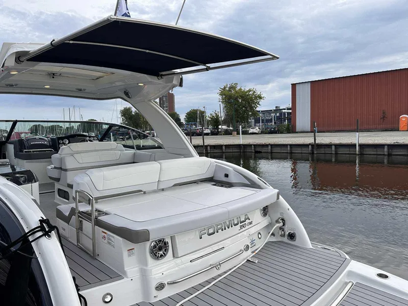 Slide: The Image of 2025 Formula 350 Crossover Bowrider I/O docked, featuring spacious seating and sleek design. - 3