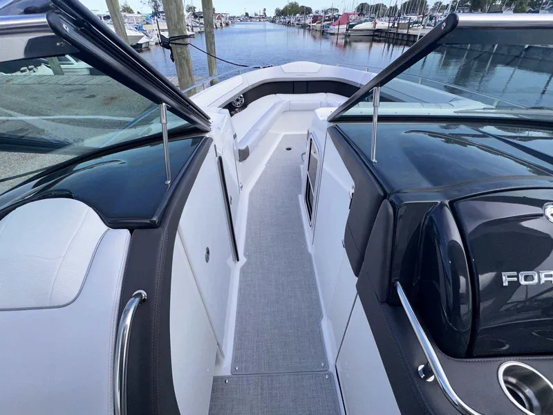 Slide: The Image of 2025 Formula 350 Crossover Bowrider I/O, sleek design, spacious deck, docked at marina. - 31