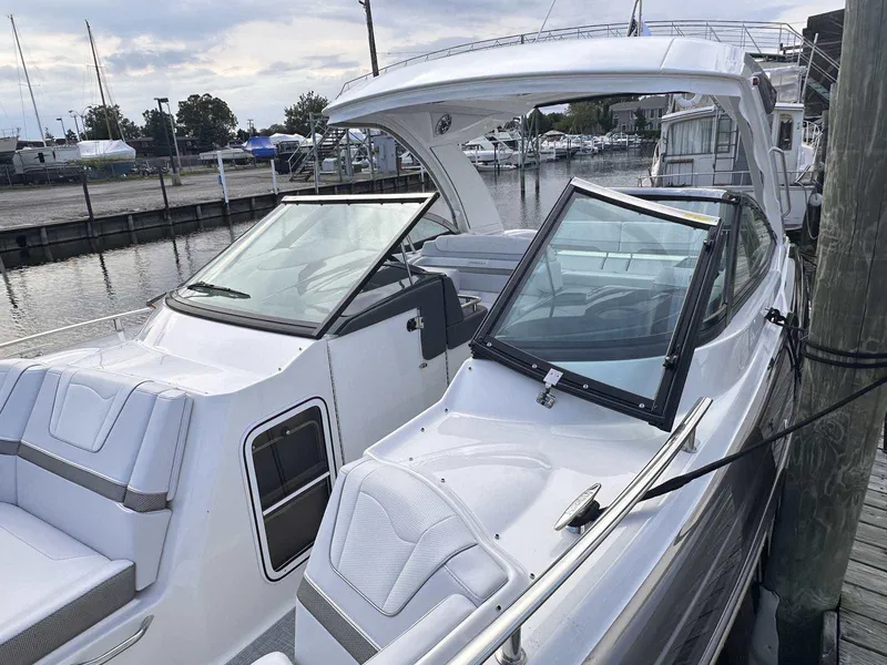 Slide: The Image of 2025 Formula 350 Crossover Bowrider I/O docked at marina, showcasing sleek design. - 32