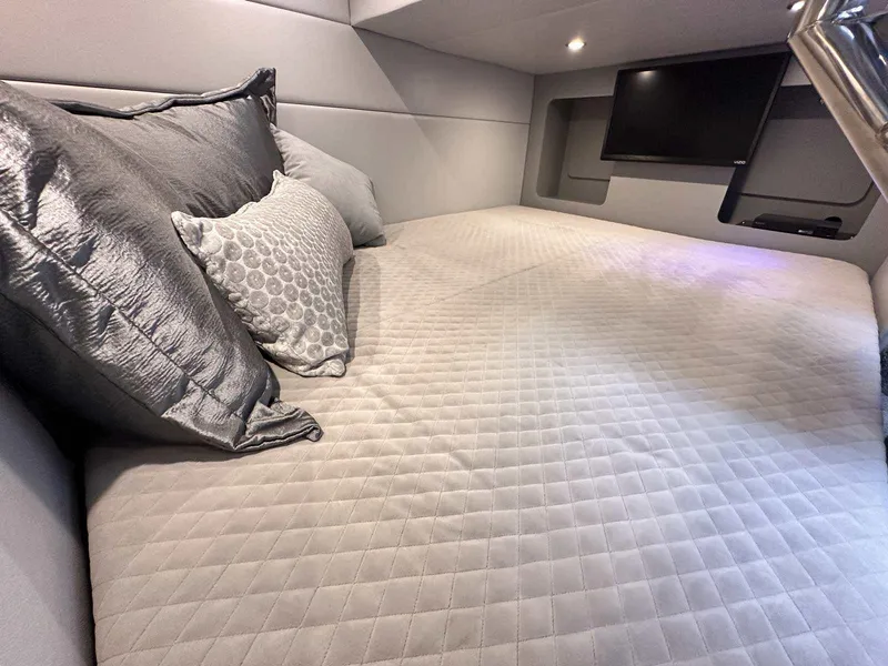 Slide: The Image of Luxurious cabin interior of 2025 Formula 350 Crossover Bowrider I/O with plush bedding. - 43