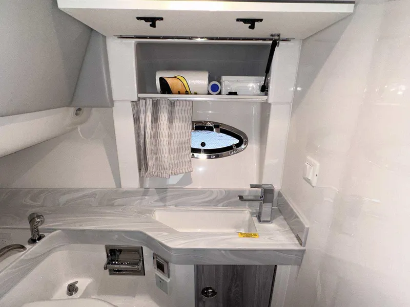 Slide: The Image of 2025 Formula 350 Crossover Bowrider I/O bathroom with modern sink and storage. - 47