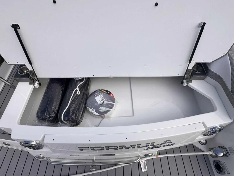 Slide: The Image of 2025 Formula 350 Crossover Bowrider I/O storage compartment with accessories. - 7