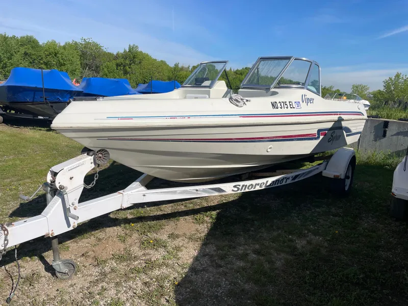 Slide: The Image of 1996 Sylvan VIPER boat on trailer in indoor storage facility. - 1