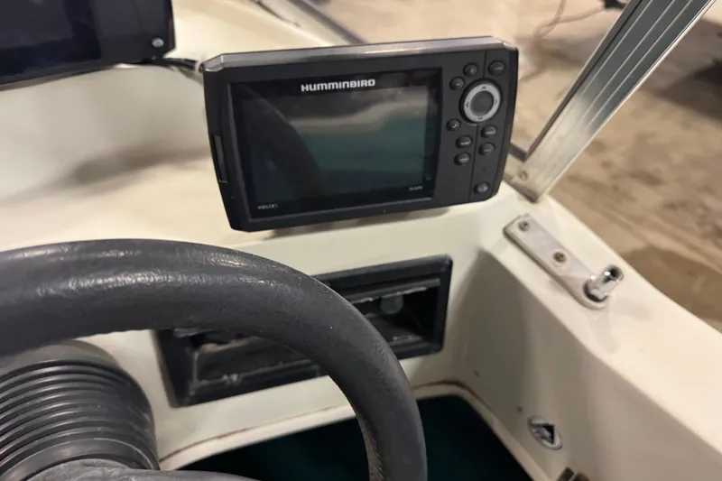 Slide: The Image of 1996 Sylvan VIPER boat dashboard with Humminbird fish finder and steering wheel. - 12