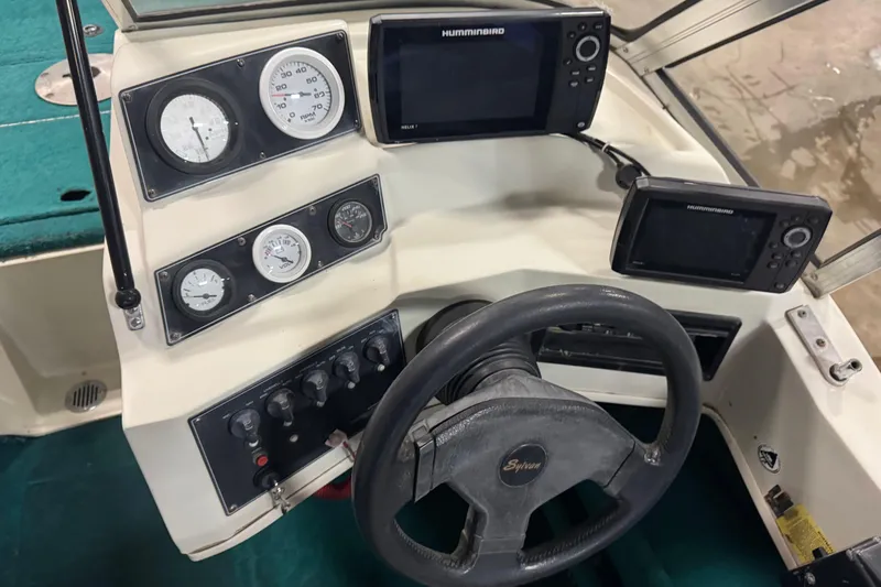 Slide: The Image of 1996 Sylvan VIPER boat dashboard with steering wheel and navigation instruments. - 14