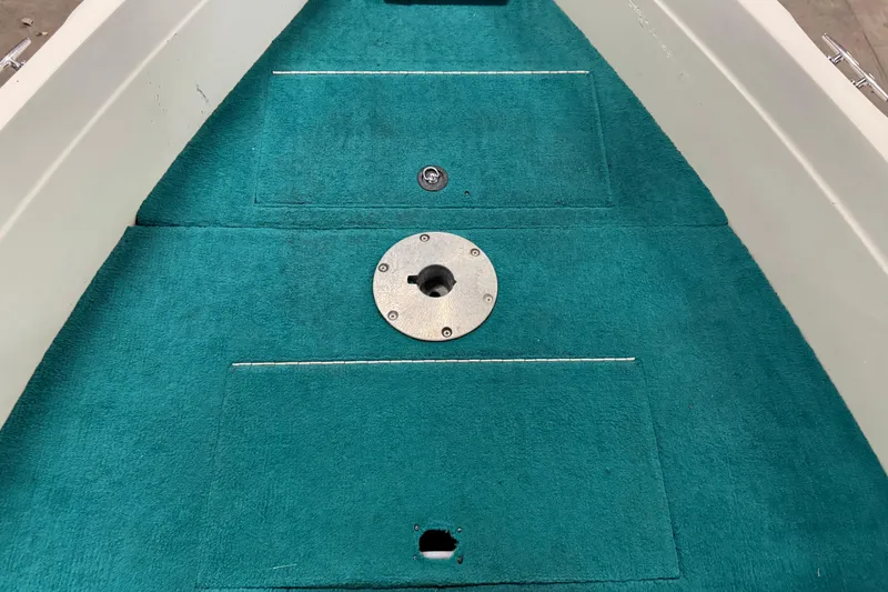 Slide: The Image of 1996 Sylvan VIPER boat interior with teal carpet and metal fittings. - 16