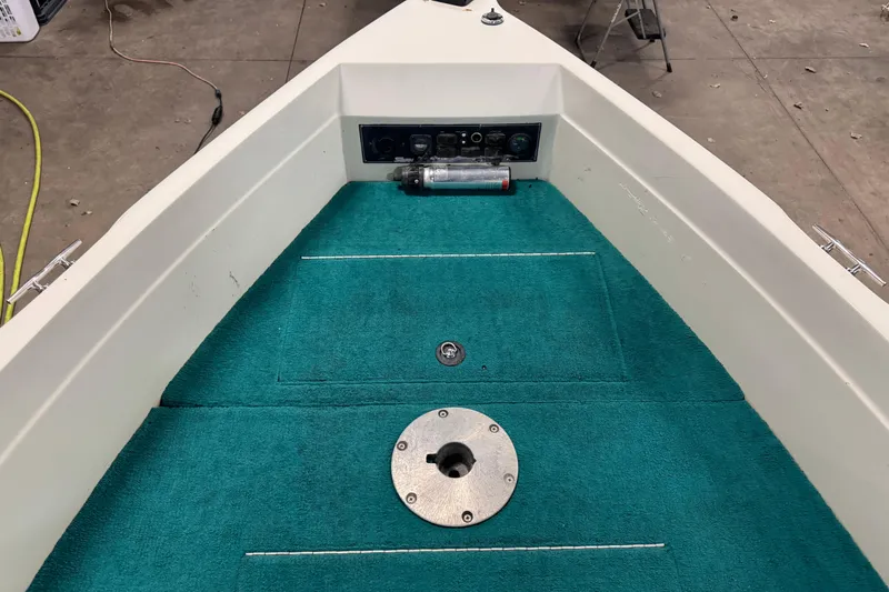 Slide: The Image of 1996 Sylvan VIPER boat interior with teal carpet and control panel. - 17