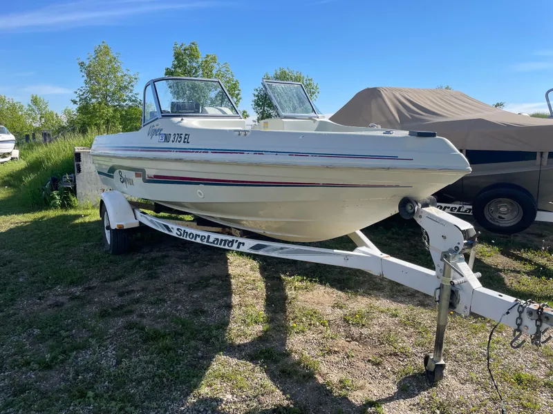 Slide: The Image of 1996 Sylvan VIPER boat on ShoreLand'r trailer in a garage setting. - 2