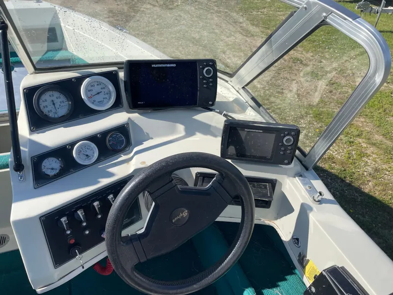 Slide: The Image of 1996 Sylvan VIPER boat with Mercury outboard motor in a garage setting. - 5