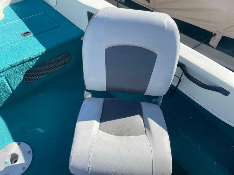 Slide: The Image of Open storage compartment in 1996 Sylvan VIPER boat with teal carpet lining. - 8