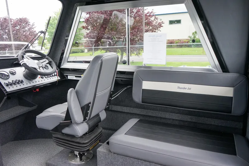 Slide: The Image of 2024 Thunder Jet 21 Chinook Pro boat interior with steering console and seating. - 12