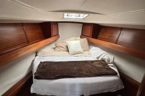 Slide: The Image of Cozy cabin bedroom in a 2000 Bavaria 42 Cruiser sailboat. - 38