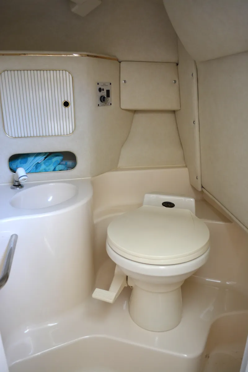 Slide: The Image of 1997 Sea Ray 280 Cuddy Cabin bathroom with toilet and sink. - 12