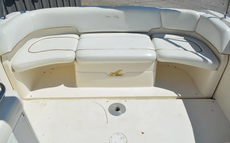 Slide: The Image of 1997 Sea Ray 280 Cuddy Cabin boat seating area with white upholstery. - 15