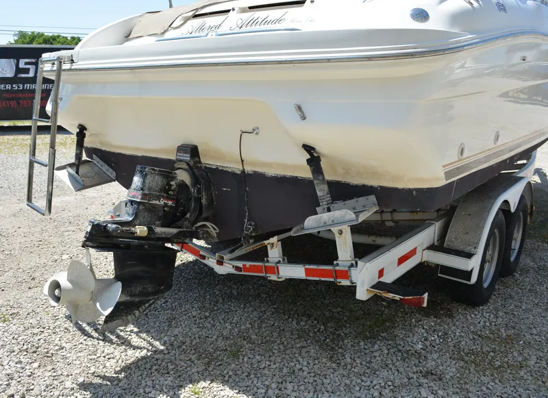 Slide: The Image of 1997 Sea Ray 280 Cuddy Cabin boat on a trailer, rear view showing propeller and outdrive. - 2