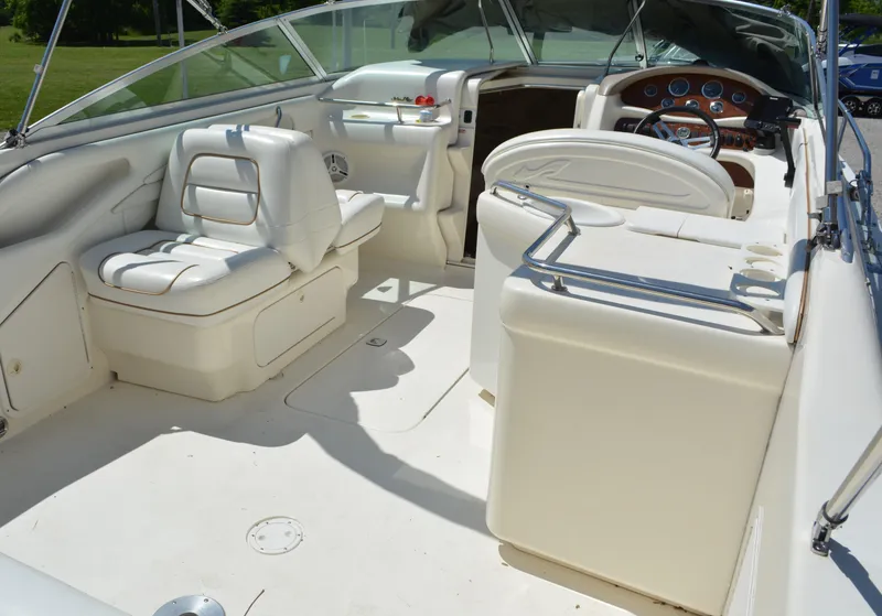 Slide: The Image of 1997 Sea Ray 280 Cuddy Cabin boat interior with white seating and dashboard. - 5