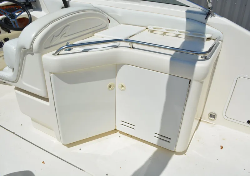 Slide: The Image of 1997 Sea Ray 280 Cuddy Cabin boat interior with storage compartments and cup holders. - 6