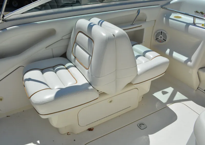 Slide: The Image of 1997 Sea Ray 280 Cuddy Cabin white leather seats in cockpit. - 7