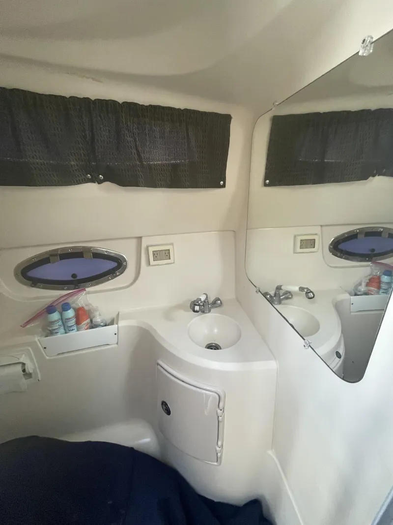 Slide: The Image of 2009 Regal 2565 Window Express boat interior with sink and mirror. - 13