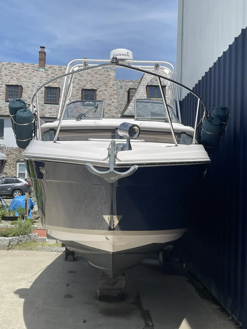 Slide: The Image of 2009 Regal 2565 Window Express boat docked between buildings. - 4