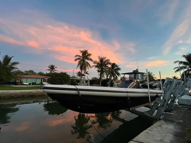 Slide: The Image of 2020 Technohull seaDNA 999 boat docked at sunset with palm trees. - 1
