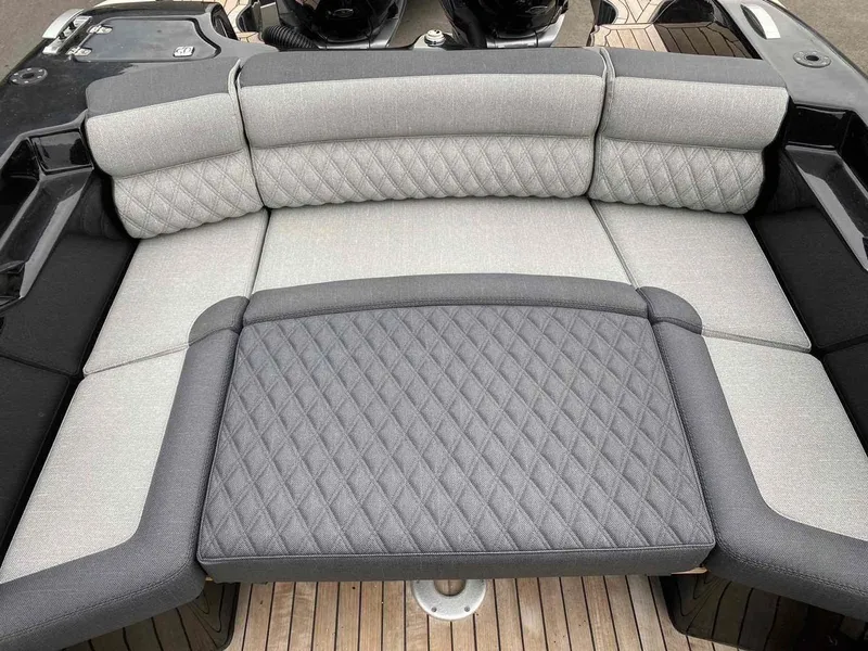 Slide: The Image of 2020 Technohull seaDNA 999 boat with cushioned seating and teak deck. - 12