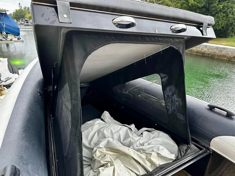 Slide: The Image of 2020 Technohull seaDNA 999 boat with open storage compartment by the water. - 21