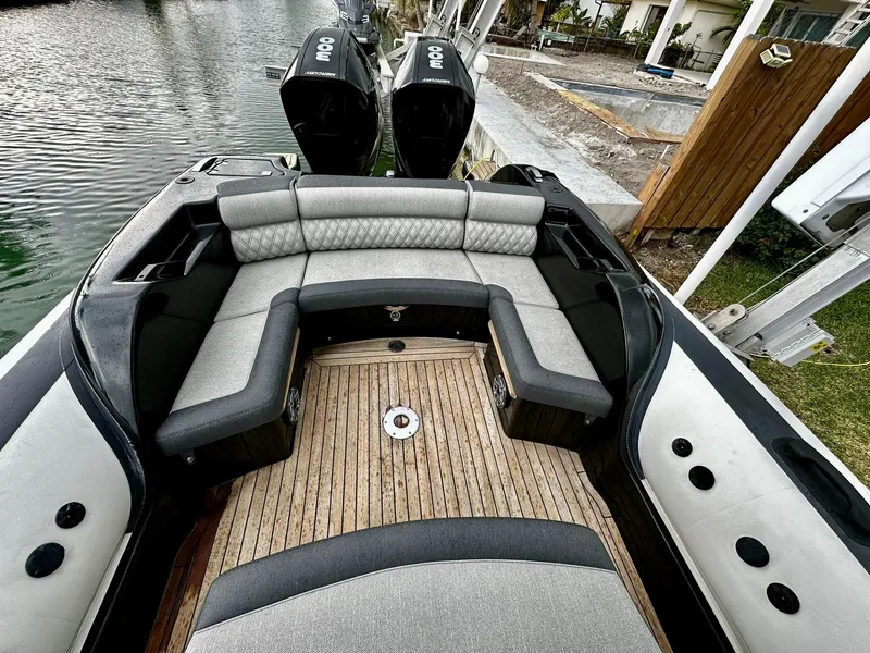 Slide: The Image of 2020 Technohull seaDNA 999 boat with cushioned seating and twin outboard motors. - 24