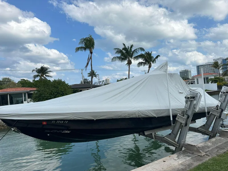 Slide: The Image of 2020 Technohull seaDNA 999 boat covered and docked by waterfront homes. - 3