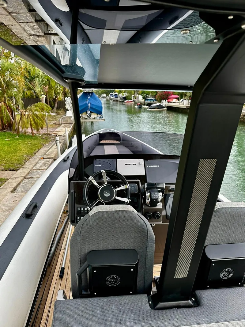 Slide: The Image of 2020 Technohull seaDNA 999 boat interior with steering wheel and canal view. - 4