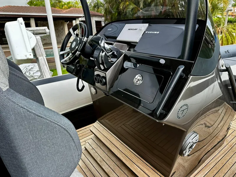 Slide: The Image of 2020 Technohull seaDNA 999 boat dashboard with steering wheel and controls. - 7