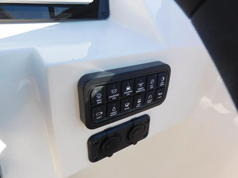 Slide: The Image of Control panel of 2024 Stingray 211 DC boat with various function buttons. - 12