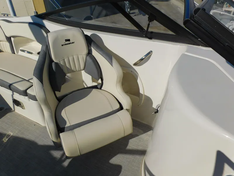 Slide: The Image of 2024 Stingray 211 DC boat interior with comfortable seating and modern design. - 13