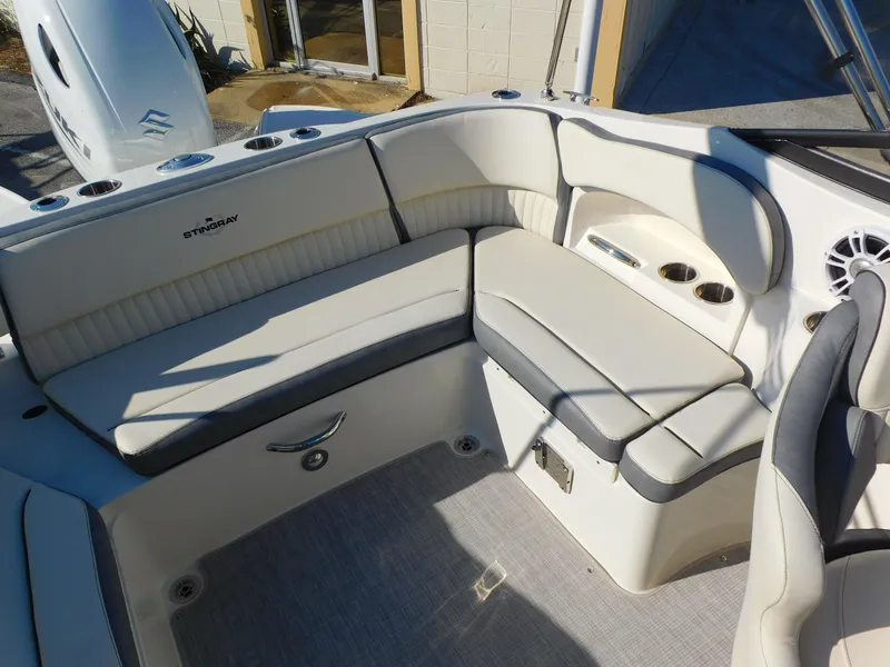 Slide: The Image of 2024 Stingray 211 DC boat interior with white and gray seating. - 14