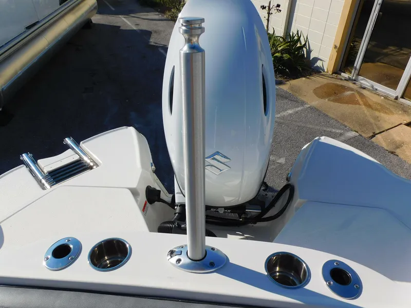 Slide: The Image of 2024 Stingray 211 DC boat stern with outboard motor and rod holders. - 17