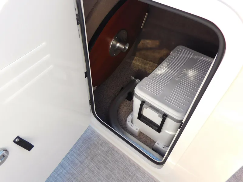 Slide: The Image of Storage compartment in 2024 Stingray 211 DC boat with cooler and equipment. - 21