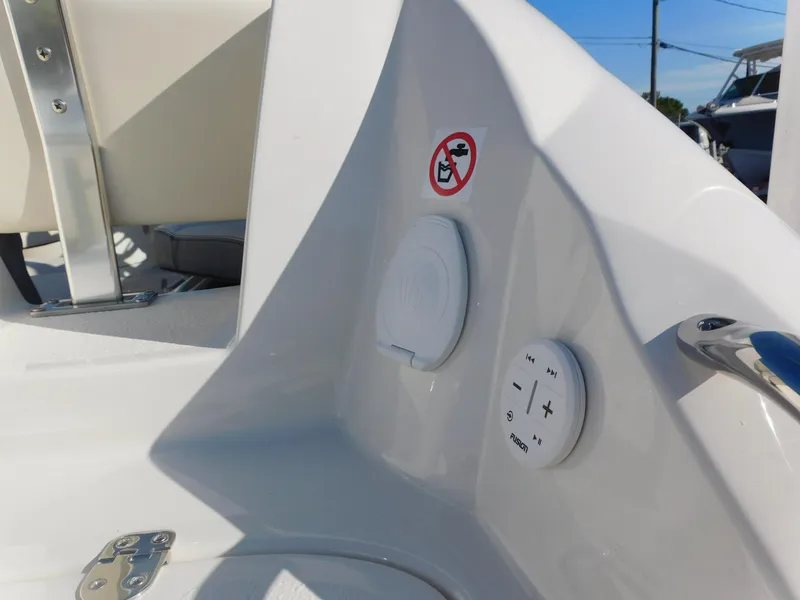 Slide: The Image of 2024 Stingray 211 DC boat interior with control panel and no smoking sign. - 22
